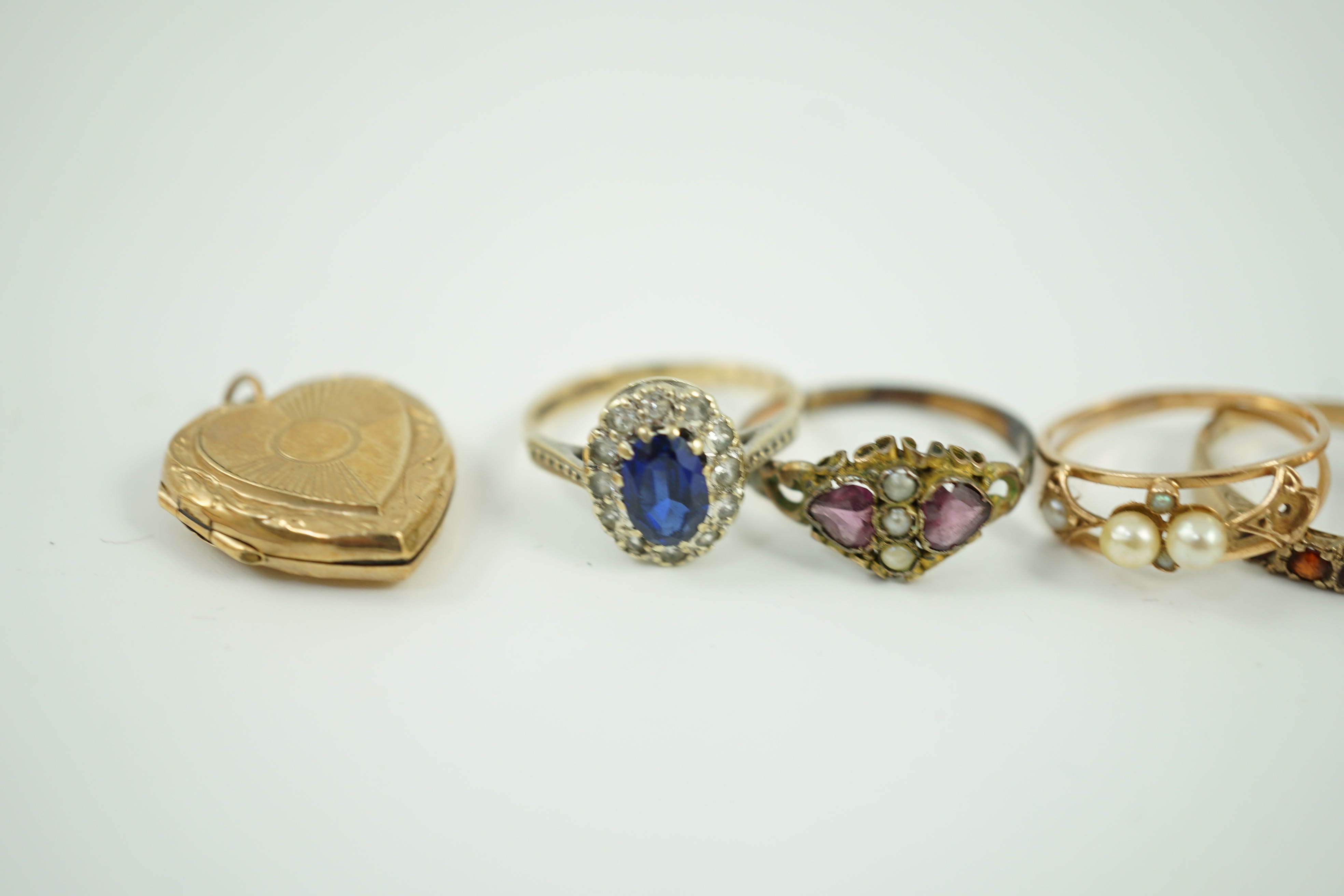 Five assorted 9ct and gem set rings, gross weight 10.9 grams, an 18ct signet ring, 1.8 grams a yellow metal and cultured pearl ring and a 9ct back and front heart locket.